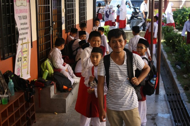 Taking a pose with students of Sekolah Rendah Agama Raja Muda Musa